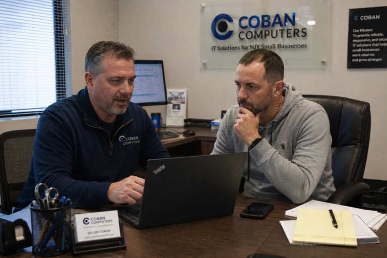 NJ small business owner reviewing IT outsourcing proposal with managed IT provider in Bergen County office